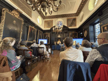 Hall full of guests listening to lecture